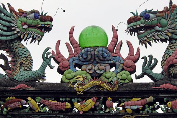 Fantasiedieren in mozaïek op een dak in Hoi An, Vietnam